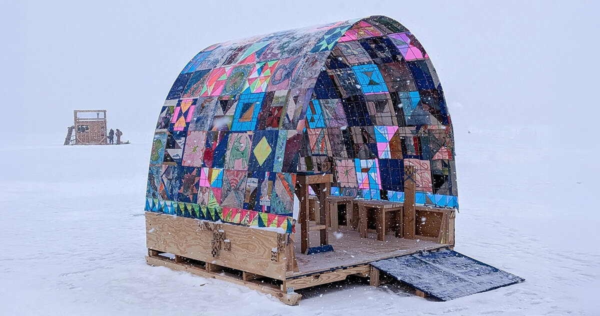 a quilt-wrapped ice shanty brings patchwork colors to a frozen minnesota lake
