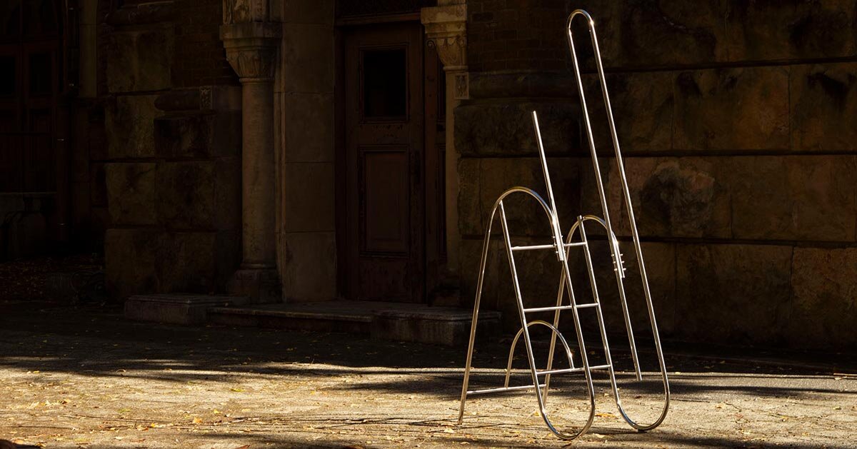 sculptural steel ladder imitates the flowing geometries of brass musical instruments