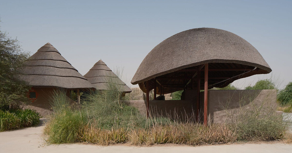 urko sánchez reinterprets african vernacular architecture in UAE with thatched pavilions