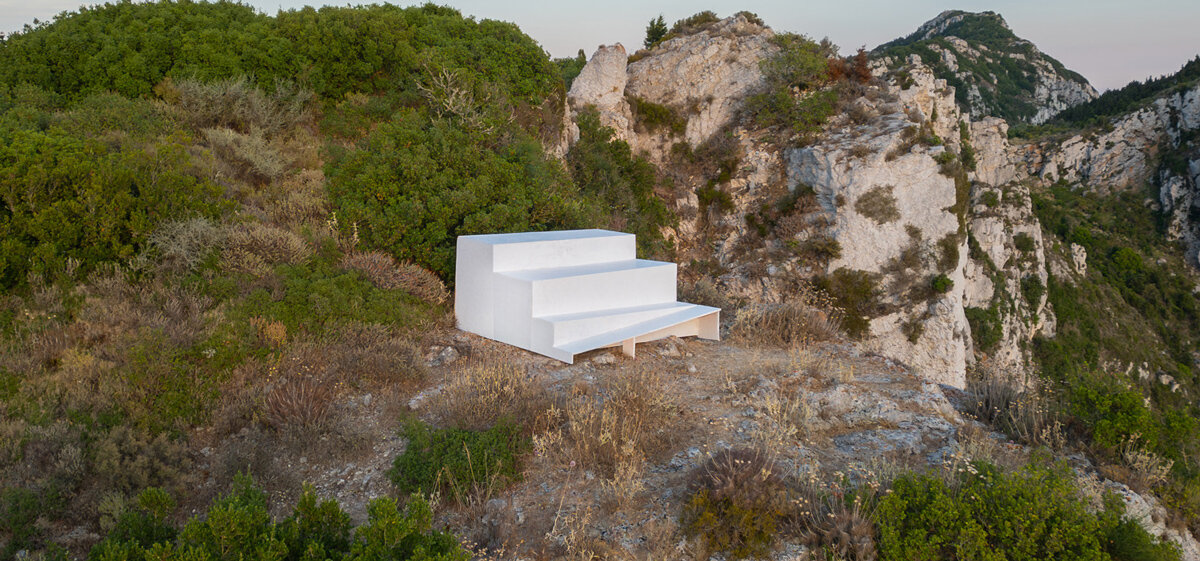 four-level white platform stands as a collective throne at the western edge of greece