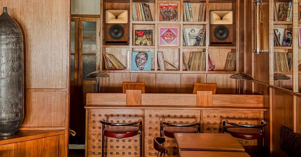 SOBO wraps paris listening restaurant in oak, vintage furniture, and acoustic panels