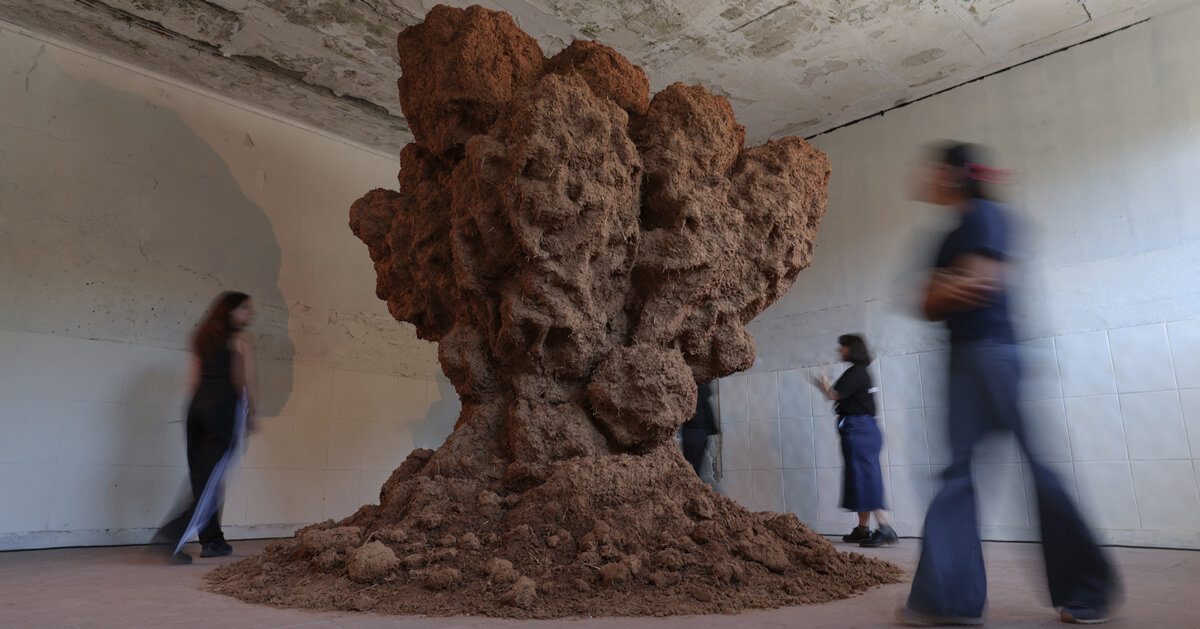 bomb cloud sculpture takes shape in soil, straw and water inside abandoned lisbon school