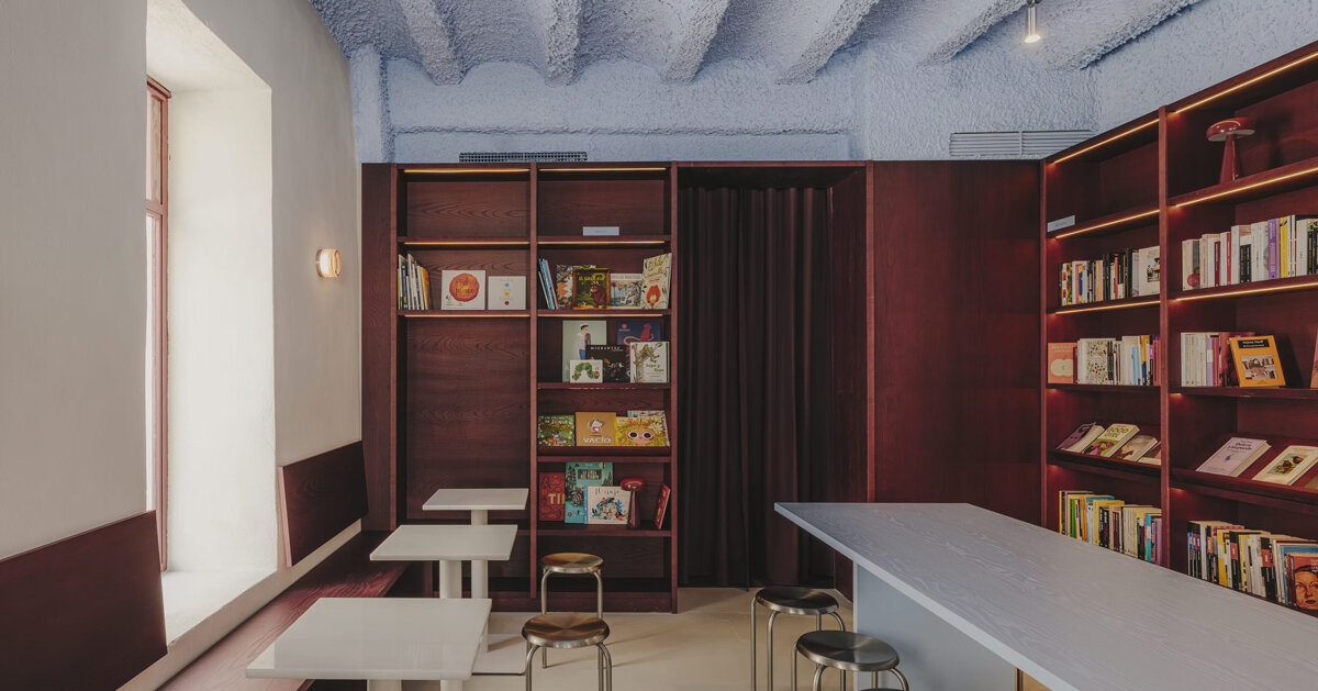 burgundy wood and blue ceilings shape café, bookshop, and wine bar in valencia