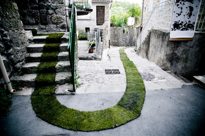 grass carpet winds through a french village