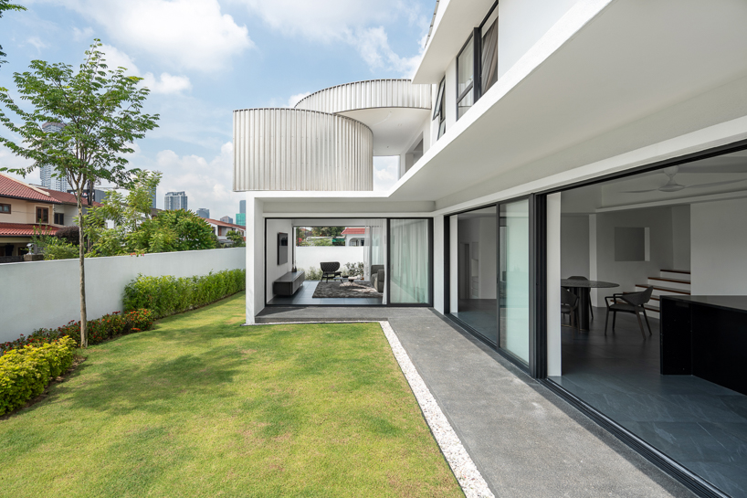 operable metal portal opens fabian tan's kuala lumpur house to the sky