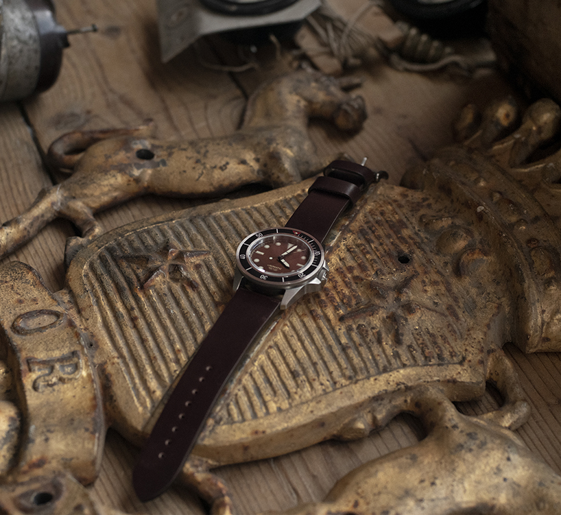 UNIMATIC x massena LAB watch features a unique patina dial and tactile black bezel designboom