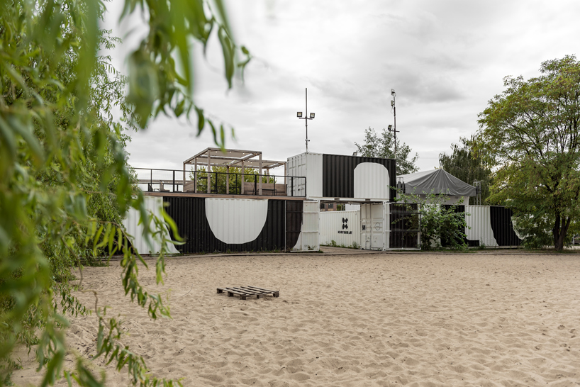 wiercinski studio recycles shipping containers for cultural center in poland designboom