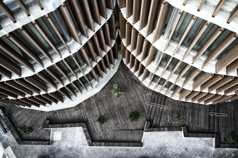 two translucent cylinders of wooden louvres extend the design college campus in ramat gan, by geotectura - 3
