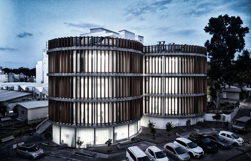 two translucent cylinders of wooden louvres extend the design college campus in ramat gan, by geotectura