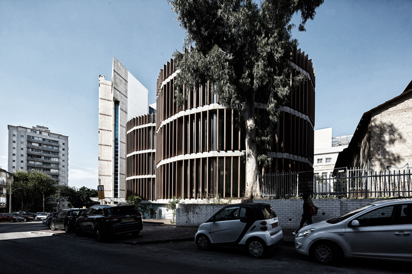 two translucent cylinders of wooden louvres extend the design college campus in ramat gan, by geotectura - 2