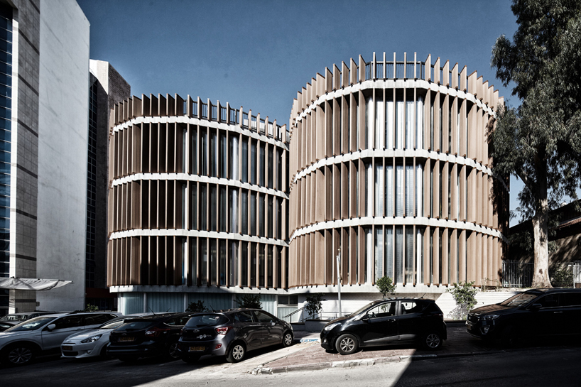 two translucent cylinders of wooden louvres extend the design college campus in ramat gan, by geotectura - 1