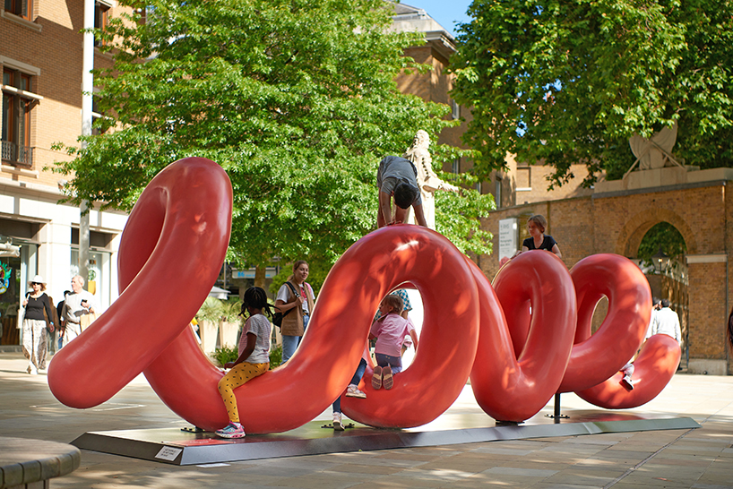 yoni alter's climbable, looping sculpture in london unravels to reveal the word 'love'