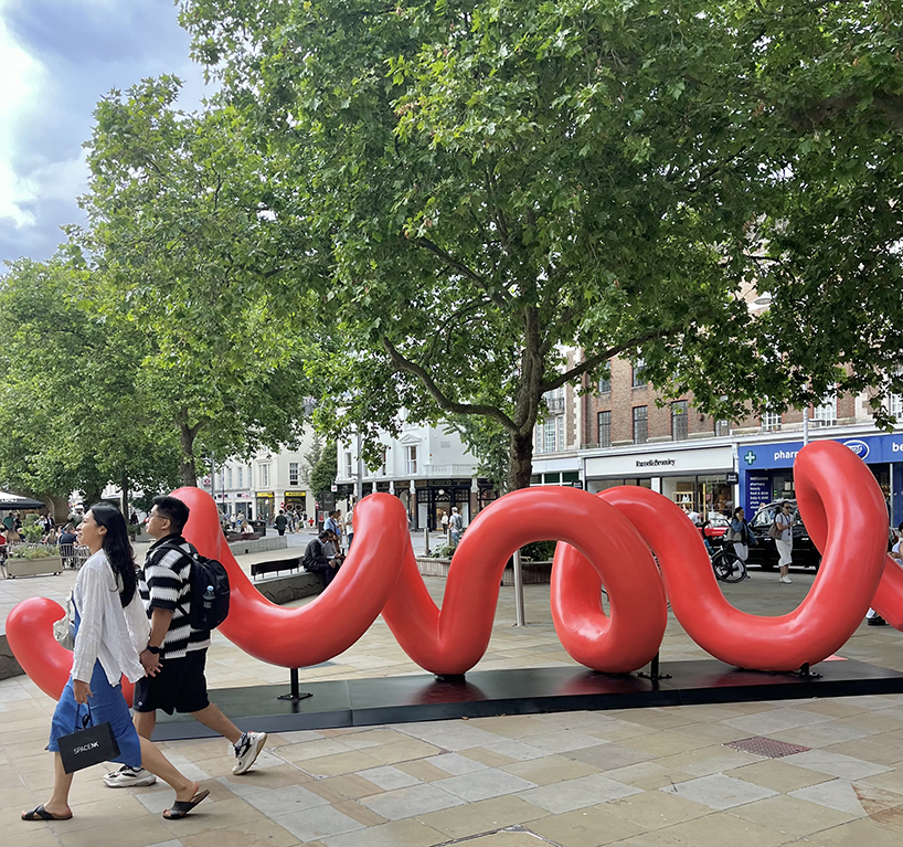 yoni alter's climbable, looping sculpture in london unravels to reveal the word 'love'