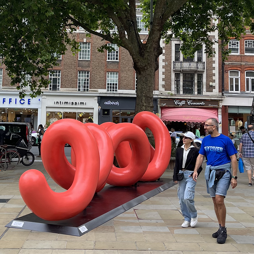 yoni alter's climbable, looping sculpture in london unravels to reveal the word 'love'