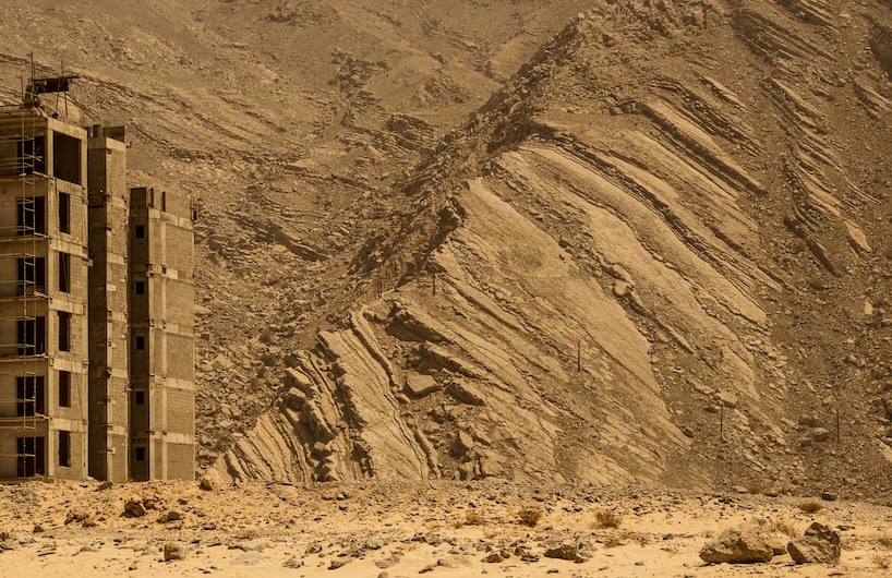 architecture contrasts against arid rock formations in manuel álvarez diestro's photo series