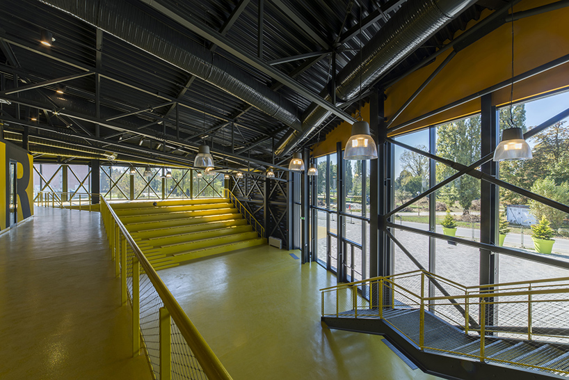 idis turato wraps yellow swimming complex interiors into black asymmetrical volume designboom