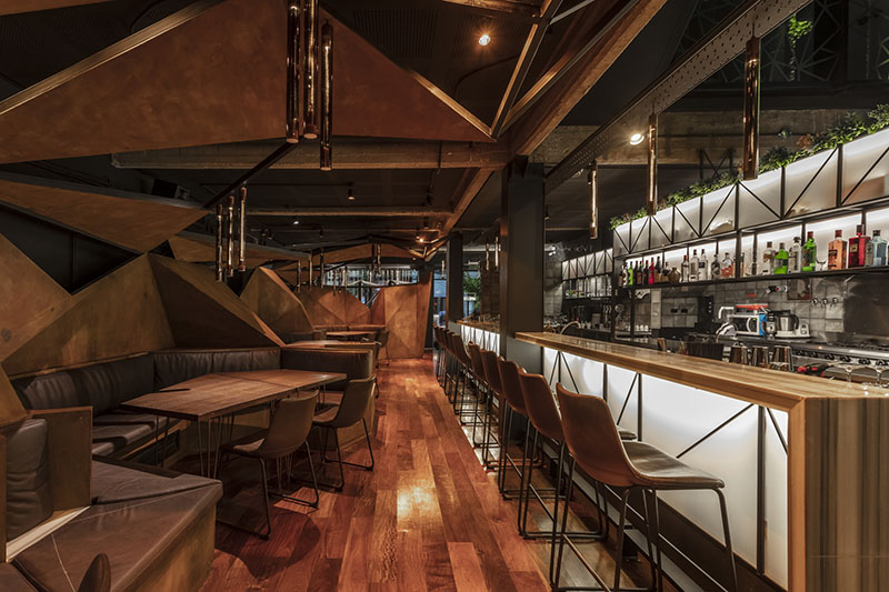 estudio HMA's mamba bar fuses oxidised iron tones with greenery in buenos aires