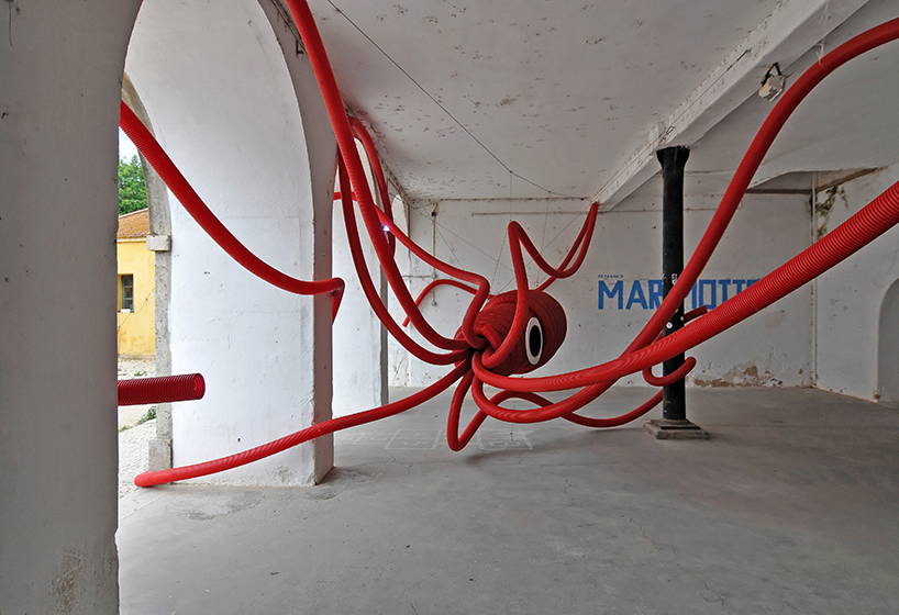 moradavaga's giant squid's tentacles embrace old beer factory in portugal