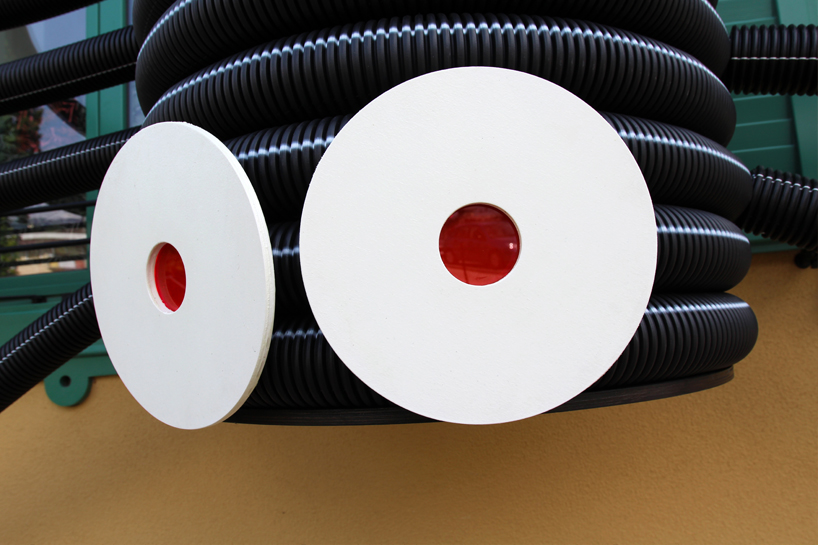 moradavaga's spider sprawls across facade in italy, reminiscent of an old-school string phone