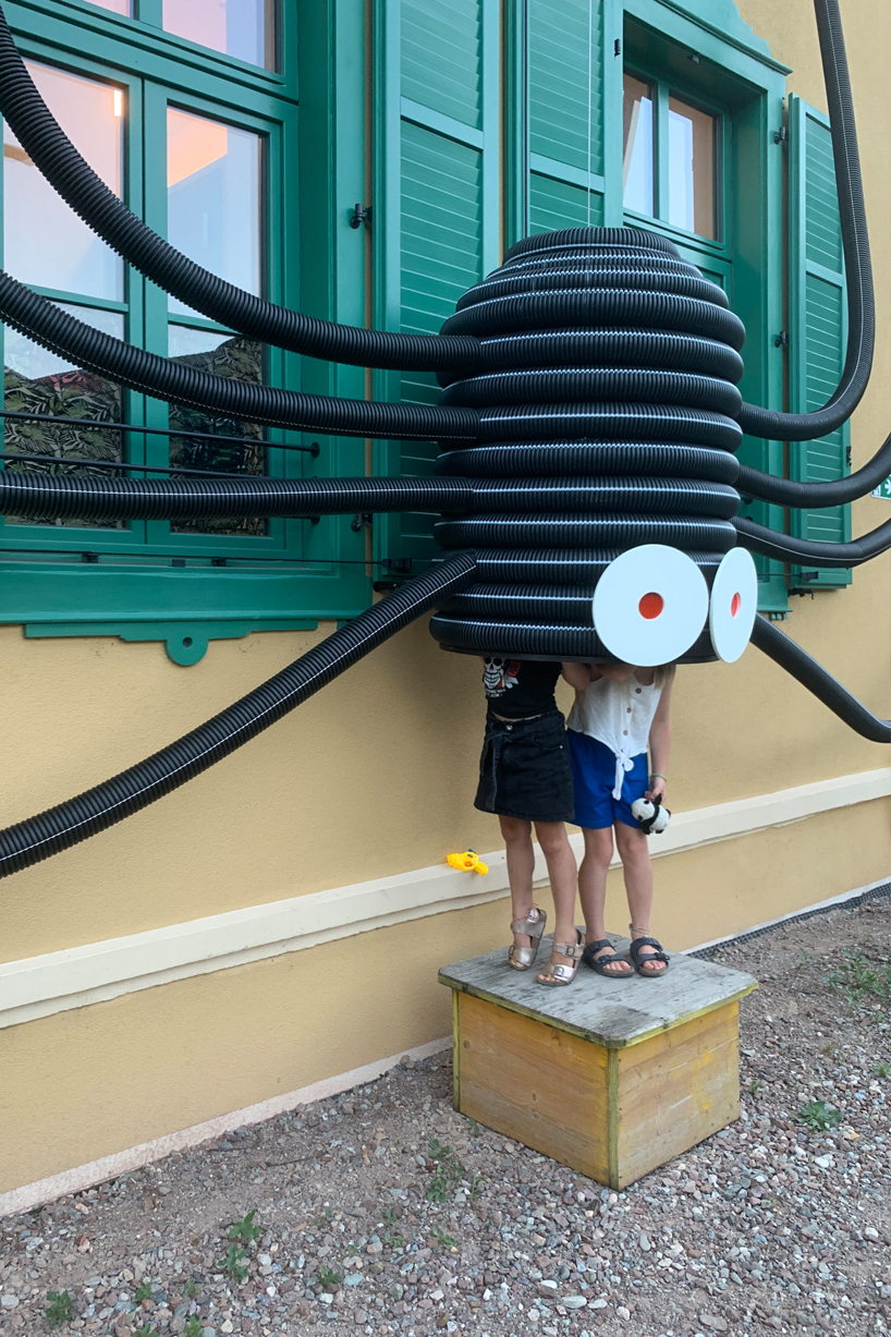 moradavaga's spider sprawls across facade in italy, reminiscent of an old-school string phone