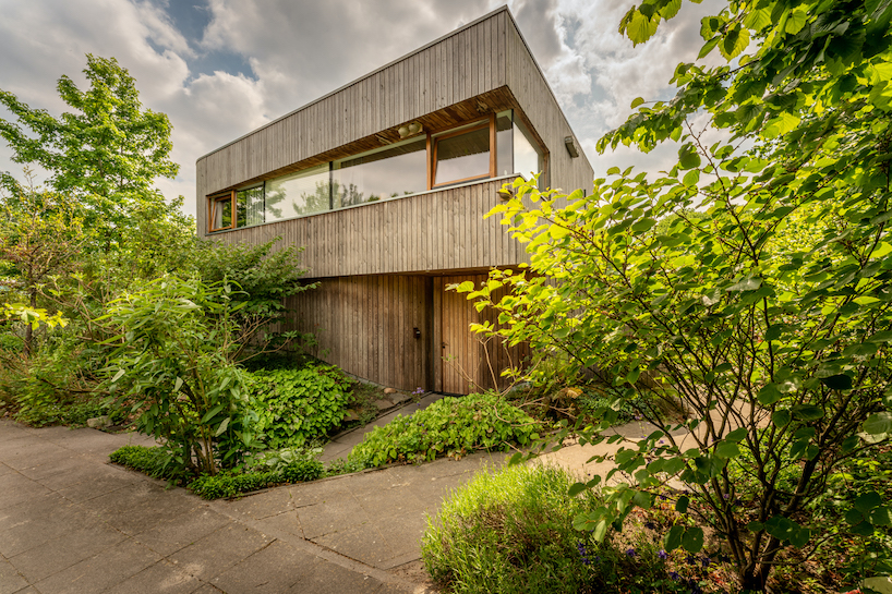 dynamic curved wooden volumes render camping villa's organic outline in amsterdam