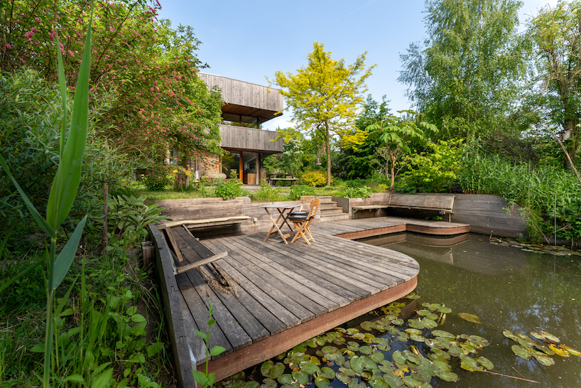 dynamic curved wooden volumes render camping villa's organic outline in amsterdam