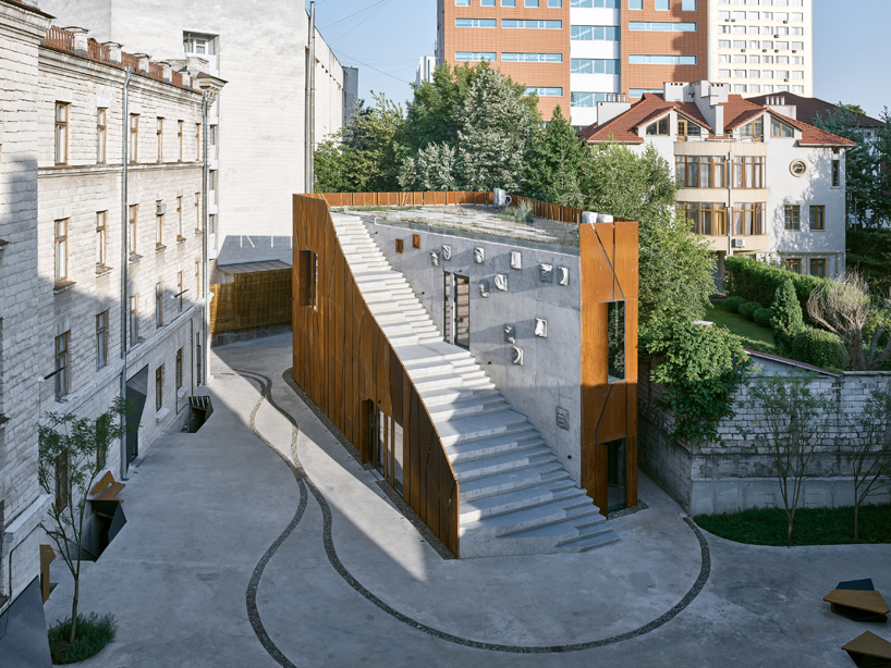 maxim calujac wraps corten steel and an external staircase around an art center in moldova designboom