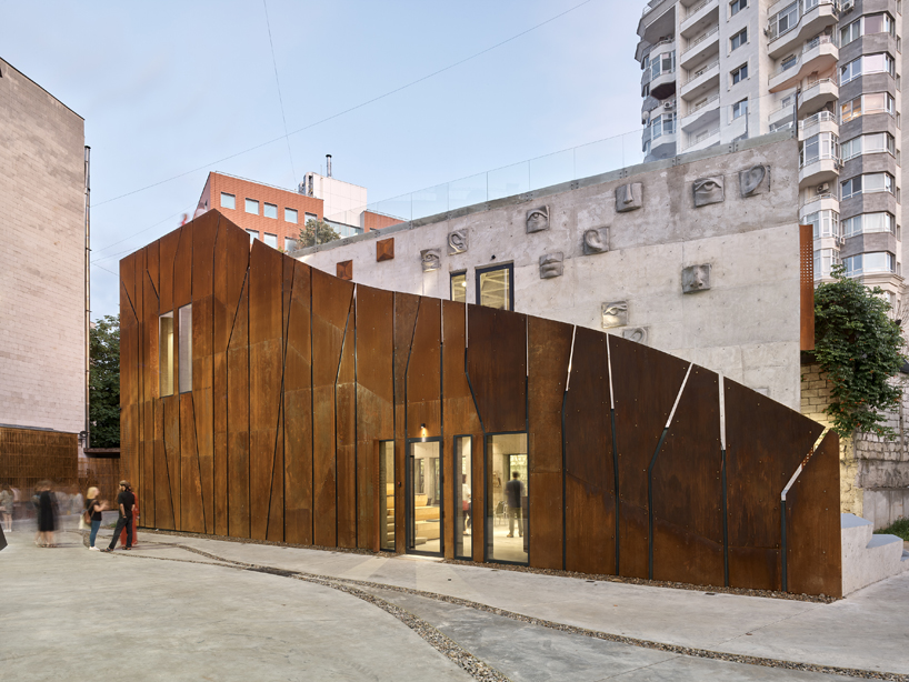 maxim calujac wraps corten steel and an external staircase around an art center in moldova designboom