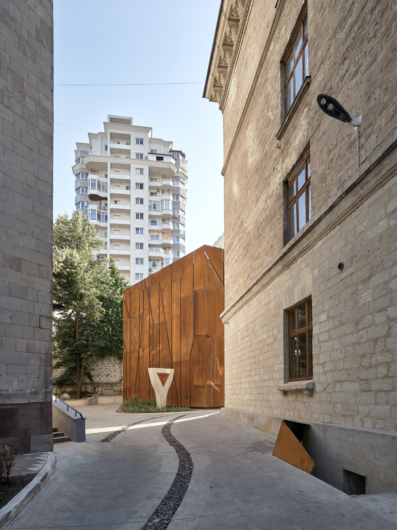maxim calujac wraps corten steel and an external staircase around an art center in moldova designboom