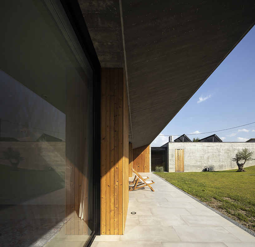 contaminar designs an l shape concrete house surrounded by olive trees in porto de mos 3