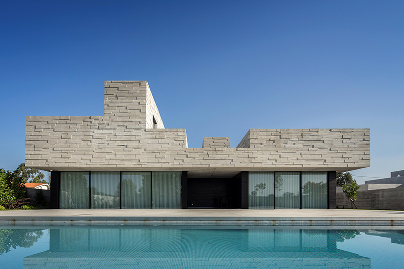 spaceworkers designs a 'house for books' with a monolithic roof in rural portugal designboom