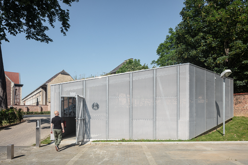WAW architects builds permeable bicycle pavilion in belgium wrapped in a mesh metal box