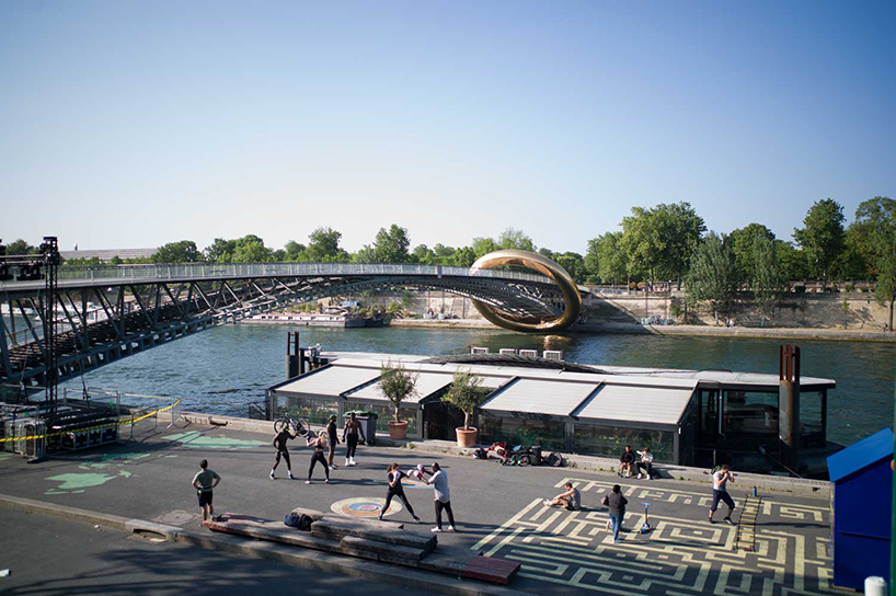 plastique fantastique's ringed installation envelops parisian footbridge for nuit blanche 2023