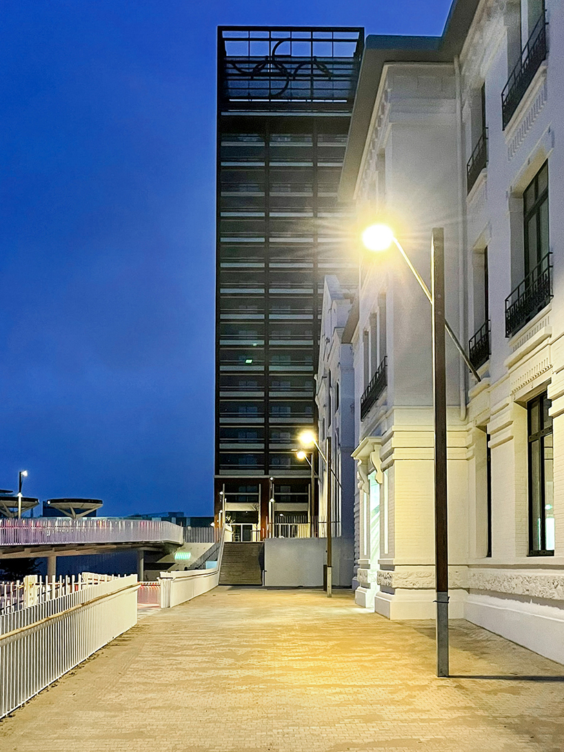 studio 5•5 repurposes old scaffolding pipes and street lamps to illuminate paris olympic village