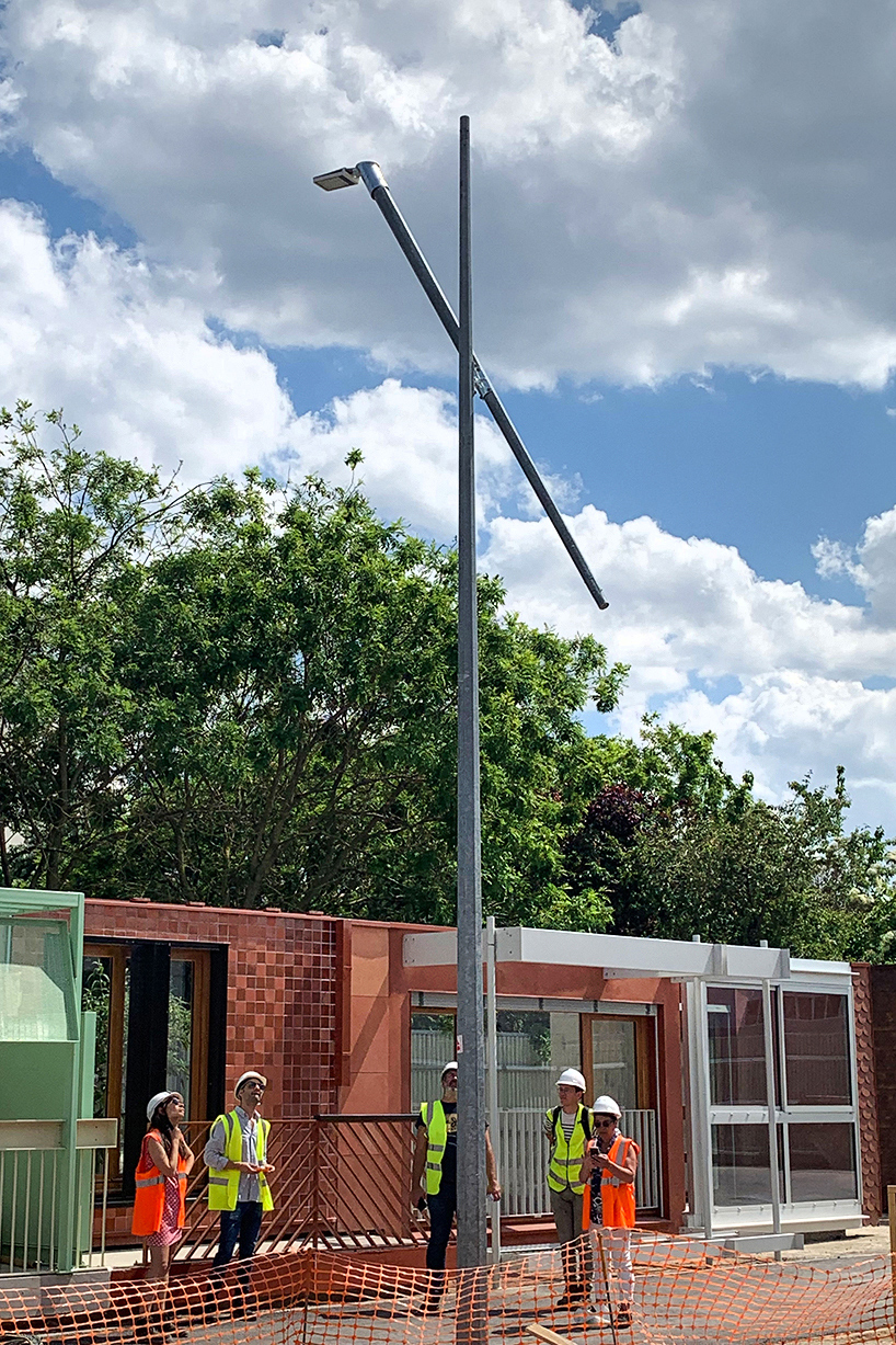 studio 5•5 repurposes old scaffolding pipes and street lamps to illuminate paris olympic village