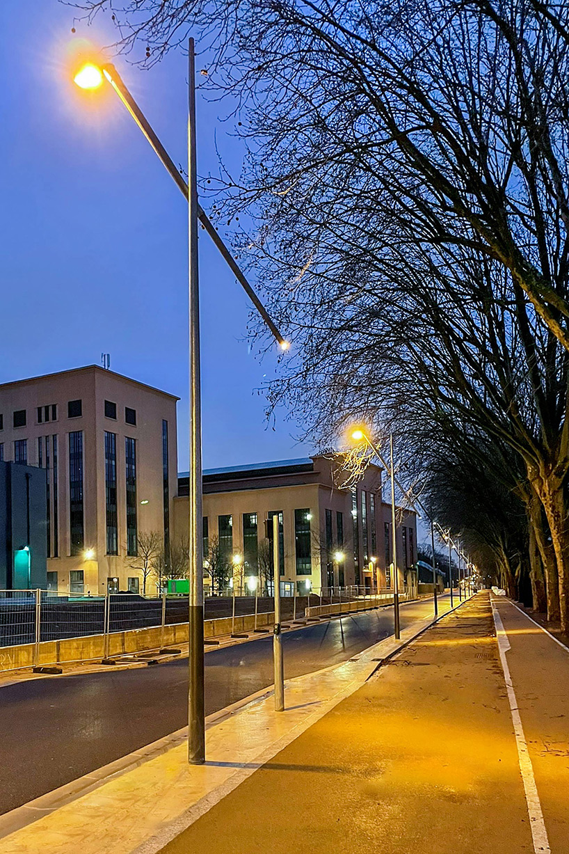 studio 5•5 repurposes old scaffolding pipes and street lamps to illuminate paris olympic village