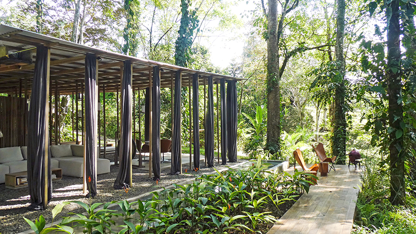 wooden columns shape open jungle house in costa rican rainforest