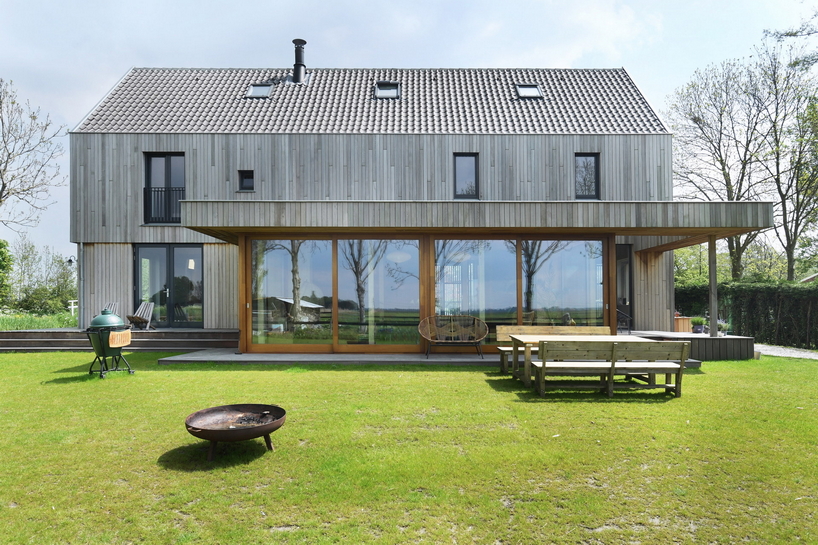 HOYT architecten assemble barn house's facade from reclaimed wood in waterland