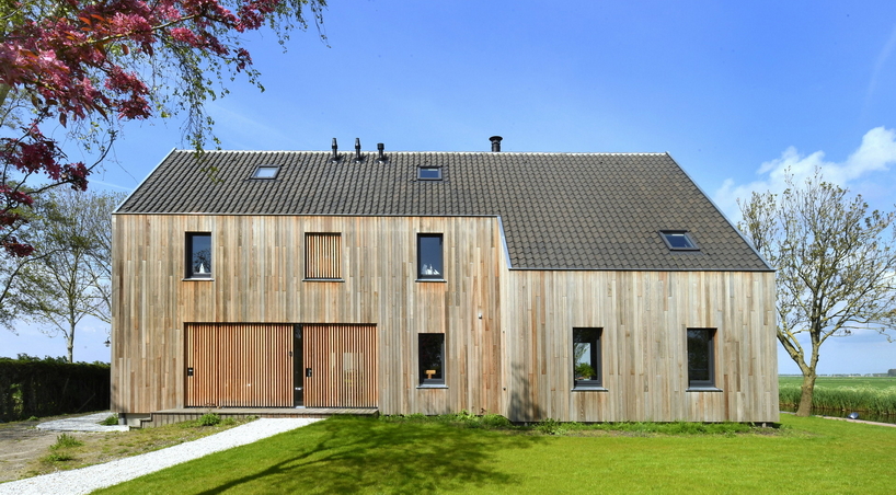 HOYT architecten assemble barn house's facade from reclaimed wood in waterland