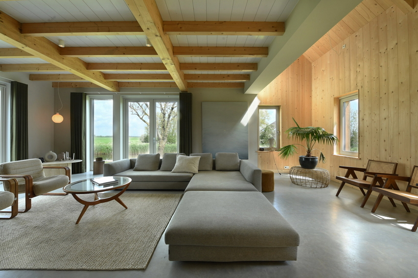 HOYT architecten assemble barn house's facade from reclaimed wood in waterland