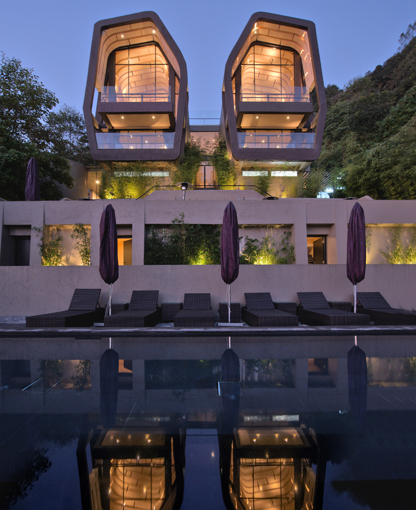 map sculpts the cloud catcher of a hillside resort in two rock like volumes 10