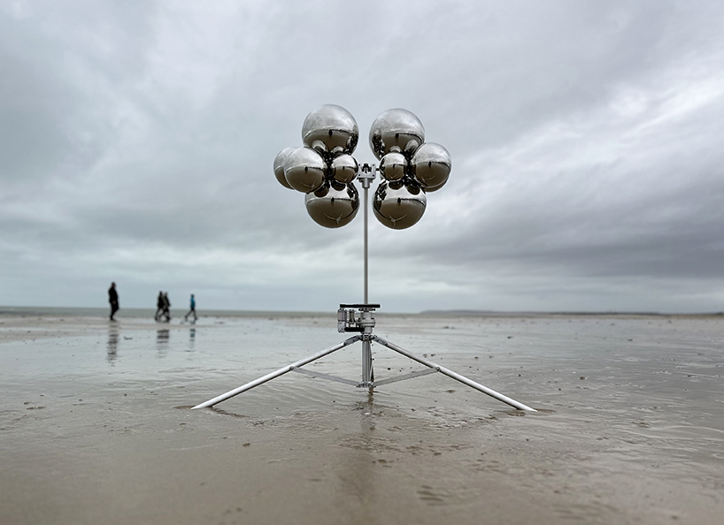 vincent leroy's kinetic mirror cloud floats between earth and sky at normandy beach