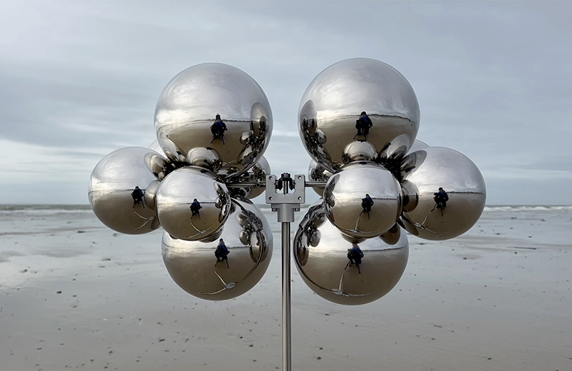 vincent leroy's kinetic mirror cloud floats between earth and sky at normandy beach