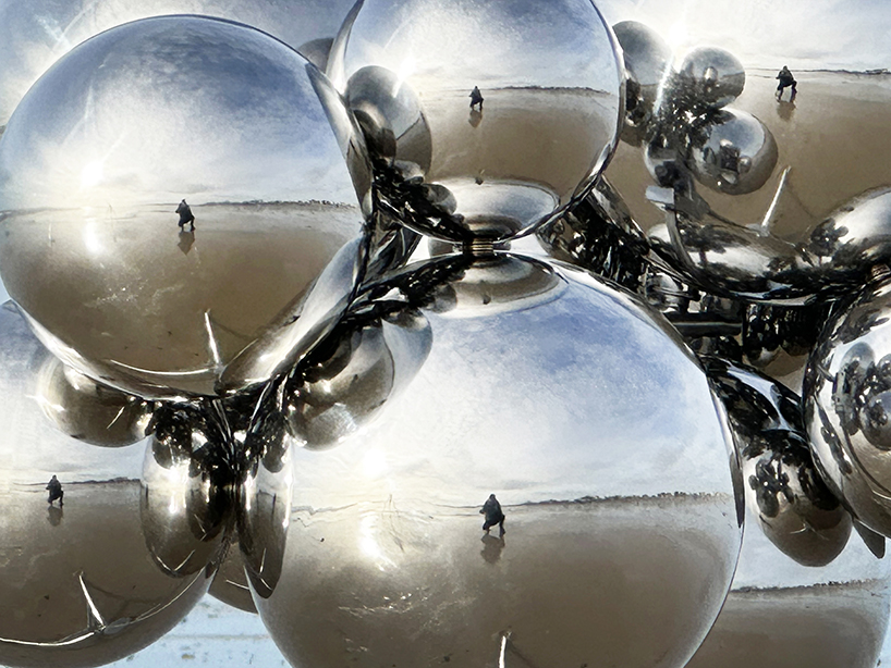 vincent leroy's kinetic mirror cloud floats between earth and sky at normandy beach