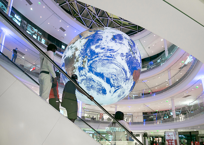 luke jerram + tetro put parisian shopping mall into orbit with globe installation