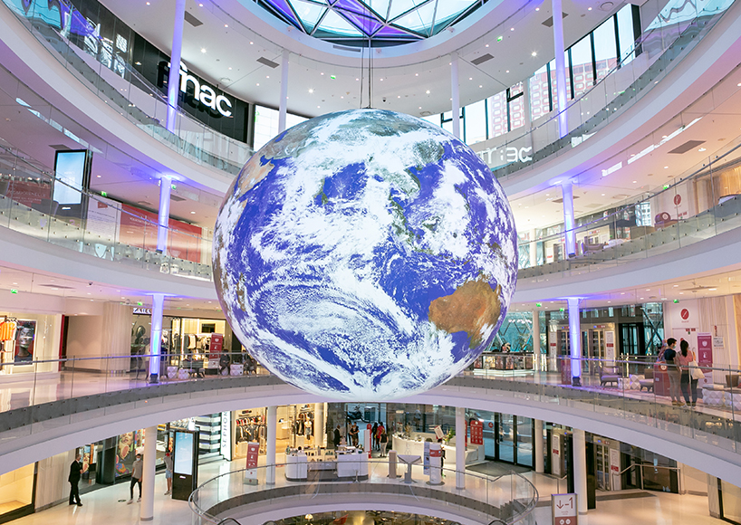 luke jerram + tetro put parisian shopping mall into orbit with globe installation