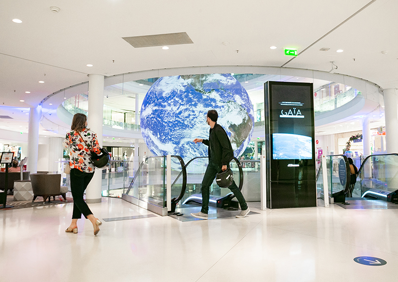 luke jerram + tetro put parisian shopping mall into orbit with globe installation