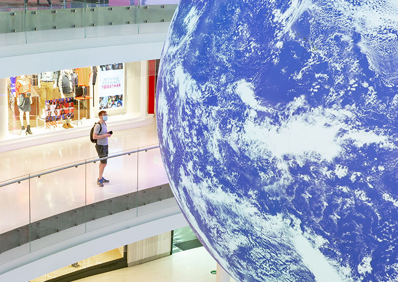 luke jerram + tetro put parisian shopping mall into orbit with globe installation