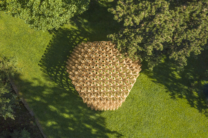 DJA introduces triangular wicker mesh pavilion in france, weaved by latvian craftsmen