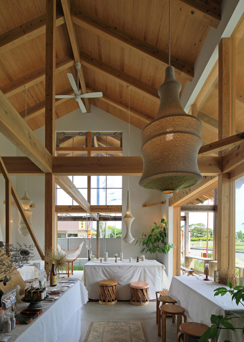 a forest of wooden pillars topped by a gently arched roof shape anandah café and residence - 7